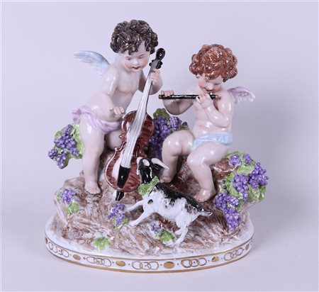 A porcelain group depicting two putti playing music, marked Sitzendorf....