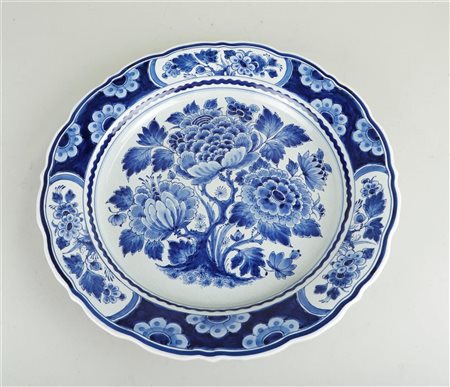 A large earthenware dish with floral decoration. The Porcleyne bottle, 1995...