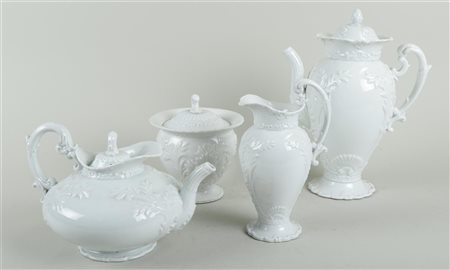 A white porcelain service with relief consisting of a coffee pot, tea pot,...