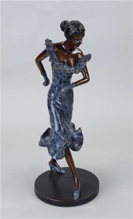 A sculpture of an elegant lady in a cocktail dress. Two-tone patinated bronze.