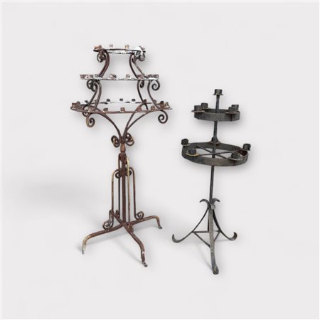 A lot consisting of (2) various wrought iron candlesticks.