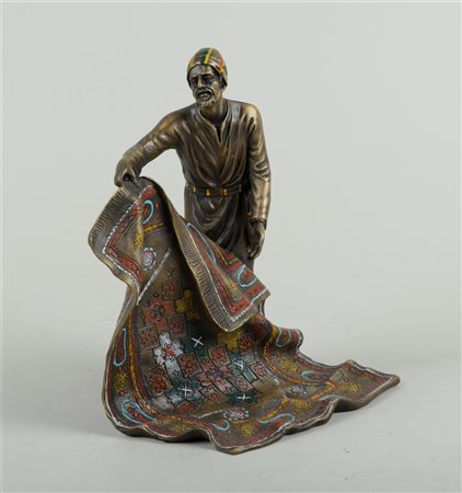 A cold-painted bronze statue of an Arab carpet merchant, in Bergmann style.22...