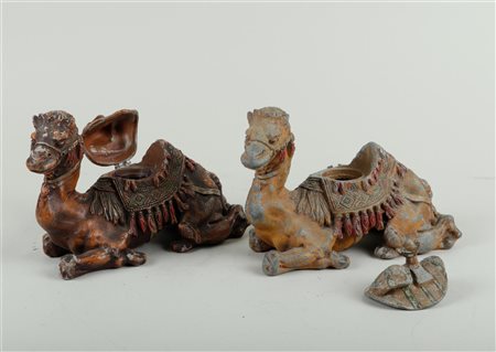 A lot of two white metal cold-painted inkwells in the shape of a camel,...