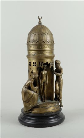 A bronze statue of a lady in a dome tower and two Arabs, in Bergman style.H....