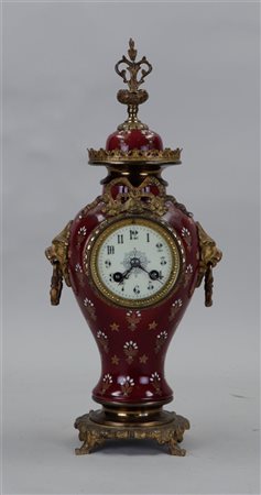 An earthenware clock with bronze ornaments. France, late 19th century.H. 42 cm.