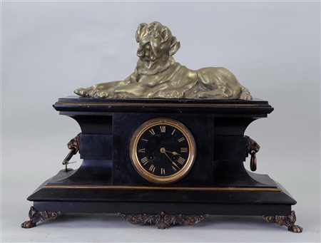 A large black marble mantel clock with a bronze reclining dog on bronze claw...