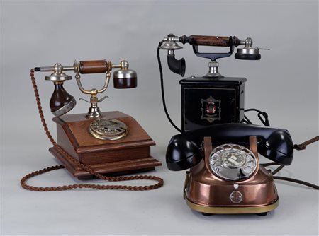 A lot of three antique telephones.