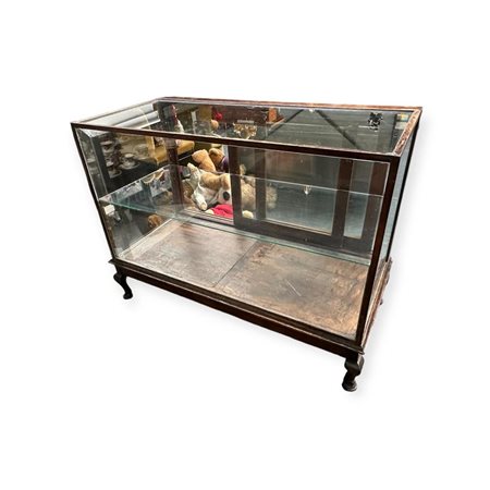 An antique shop display case on wooden "Chippendale" legs. 1st half 20th...