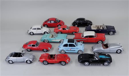 A collection of 1:24 scale model cars and motorcycles manufactured by...