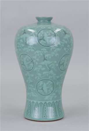 A green glazed Celadon Mei Ping vase, with representations of cranes in...