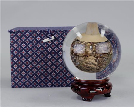 A hand-painted glass globe on a wooden stand. China, 20th century.