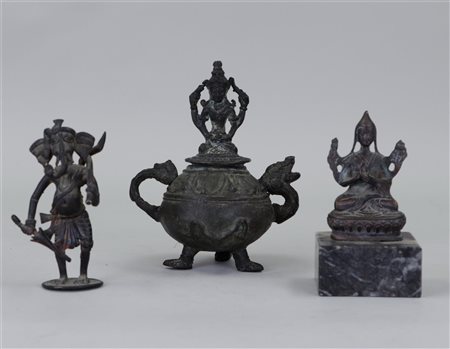 A lot of three bronze sculptures consisting of a Buddha incense burner and...