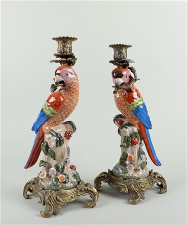 A set of polychrome painted earthenware candlesticks in the shape of a...