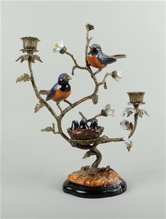 Two bronze candlesticks decorated with various earthenware birds. One bird is...