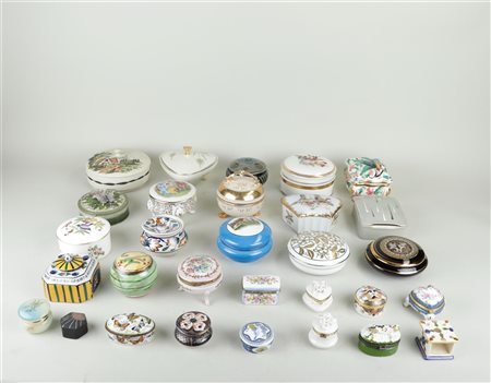 A large collection of porcelain lidded boxes with various decorations.