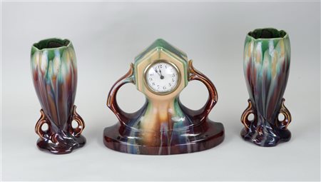 A Flemish Art Nouveau earthenware clock set.H 25 - 30 cm.