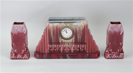 A Flemish earthenware red glazed Art Deco mantelpiece set.H. 31 cm.