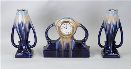 A Flemish Art Nouveau earthenware clock set.H. 27 cm.