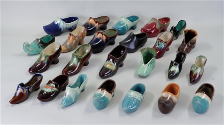 A collection of various glazed Flemish pottery shoes and clogs.