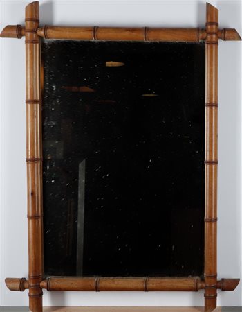 A vintage wall mirror with a faux bamboo frame, ca. 1900. 77 x 57,5 cm.