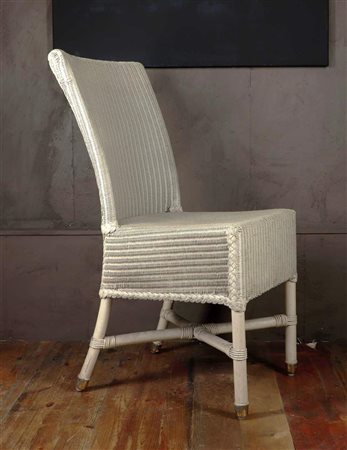 A white lacquered Lloyd Loom chair designed by Vincent Choppard, ca. 1950....