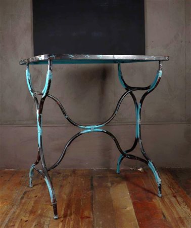 An iron garden table or plant table with remains of green polychrome. First...