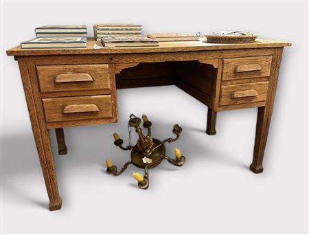 An oak desk, ca. 1930. The objects on and under the desk do not belong to...