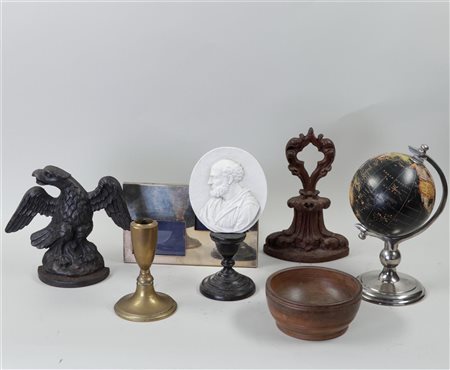 A collection of various items including a globe, photo frame and medallion on...