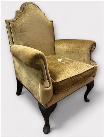 An Italian armchair upholstered in gold-coloured velvet. 19th century.