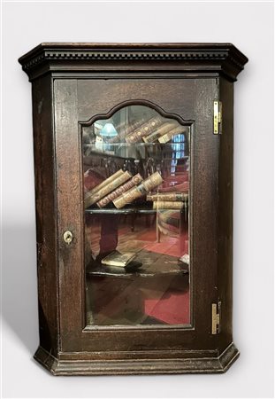 A late 18th century corner cupboard with shelves and glass door. NB: The...