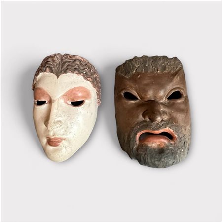 Two polychrome terracotta masks, marked and dated on the inside. 24 x 18 cm.