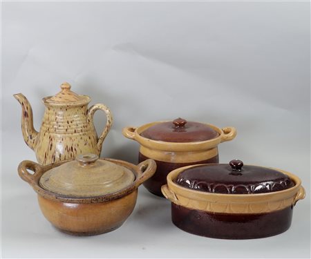 A lot of earthenware casserole dishes with lids. Including one coffee pot.