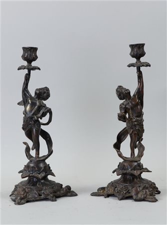 A pair of bronze candlesticks with putto on grapevine base. Circa 1870. H. 33...