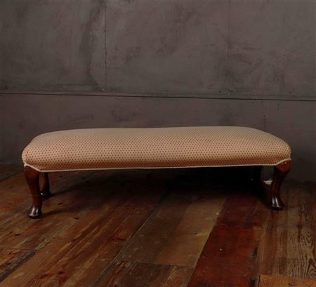 A 19th century footstool upholstered in yellow worked fabric. 25 x 98 x 35 cm.