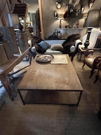 A teak coffee table on an iron base. 140 x 100 x 45 cm.