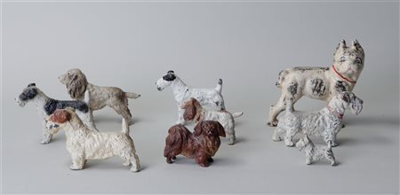 A collection of nine antique cold painted metal dogs. 9 x 9 cm.