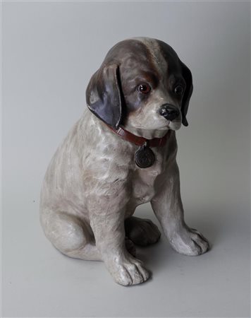 An earthenware polychrome figure of a puppy. 33 x 14 cm.