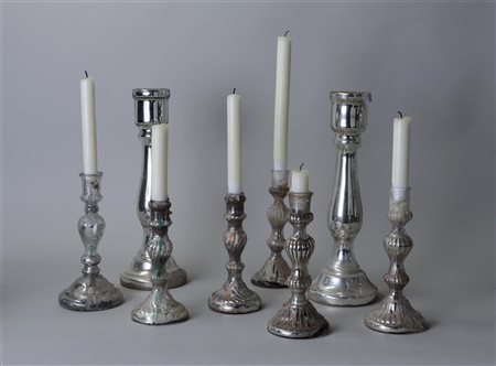 A collection of eight silver-plated glass candlesticks. H. 25 cm.