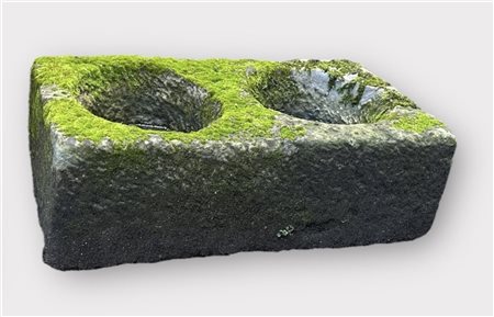 A stone trough with two carved compartments. 81 x 43 x 28 cm.