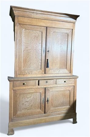 A light oak sideboard with drawers and two doors in the lower cupboard, and...