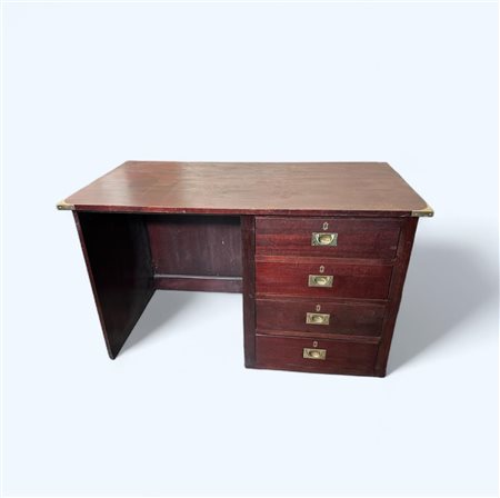 A colonial campaign style desk with brass corner mounts and recessed handles....