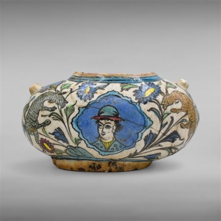 A pottery begger¿s bowl (Kashkul) Qajar Iran, 19th century
Alms bowl with figurative, plant and zoomorphic decoration.