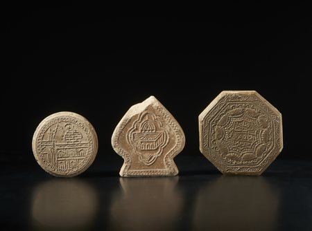 Group of three clay praying plaques (turbah)