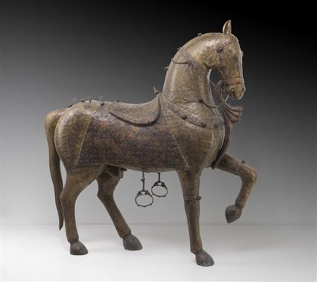 A highly decorative large wooden horse coated with embossed and engraved copper sheet