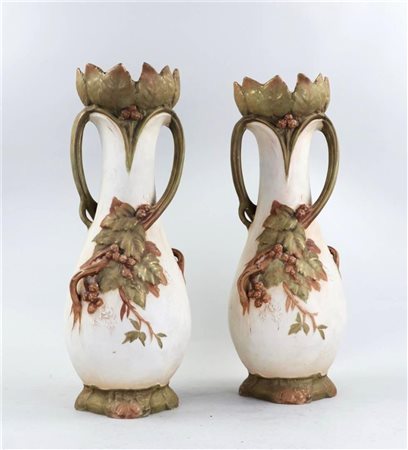 A pair of large Royal Dux decorative vases with floral motifs. Marked (on the...