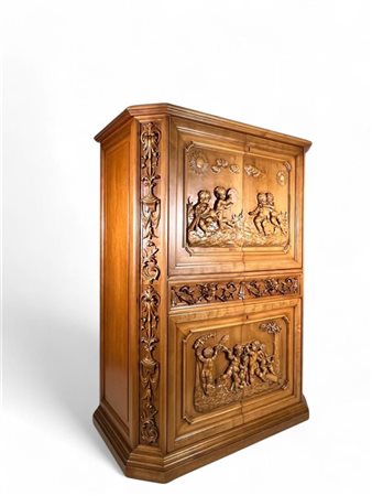 A fruitwood sideboard with high relief scenes of putti, garlands and vases....