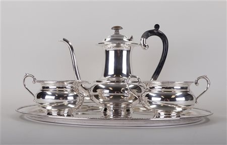 A sterling silver coffee/tea set consisting of a tray, a cream set and a...