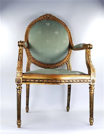 A Louis XVI style armchair with green upholstery.