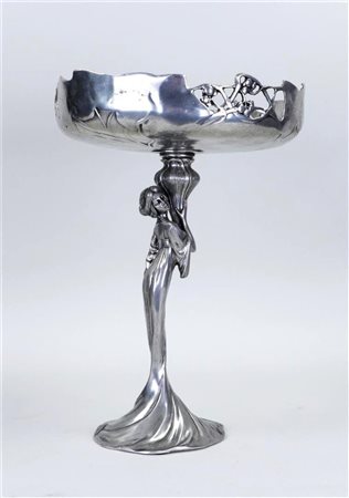 A pewter Art Nouveau table piece in the shape of a lady holding up a bowl,...