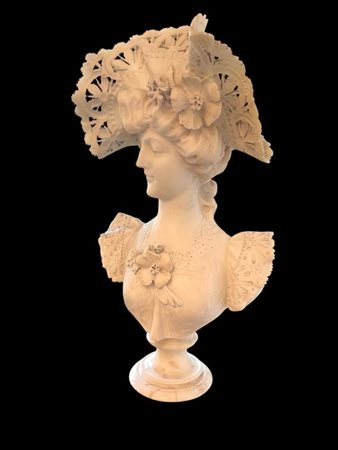 An alabaster bust of a young lady in evening dress and a beautiful open-sawn...